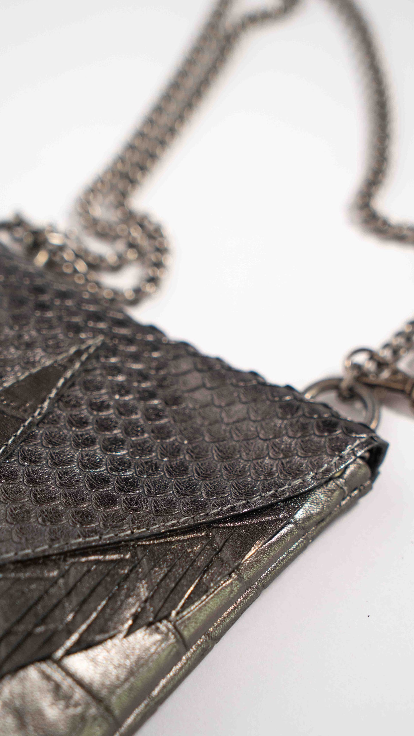 Convertible luxury grey leather bag worn around the waist as a stylish belt bag, handcrafted in Ibiza.