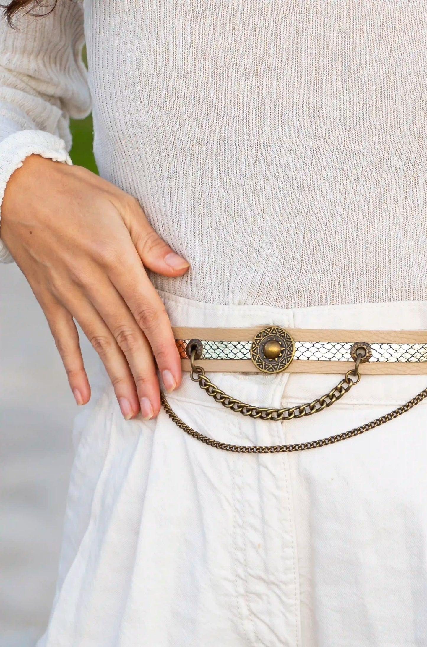 Beige snake leather belt used as a unique accessory for boots, handcrafted in Ibiza.