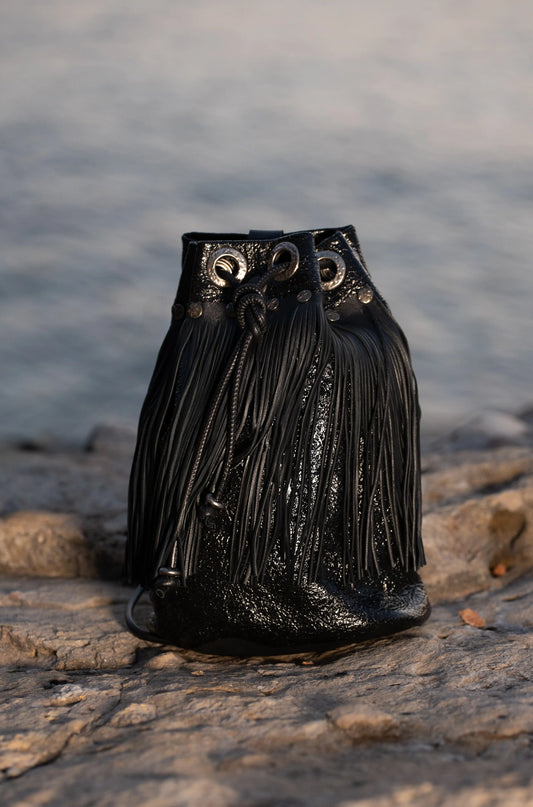 Luxury handcrafted black leather bag with fringes, artisan design from Linda Ibiza.