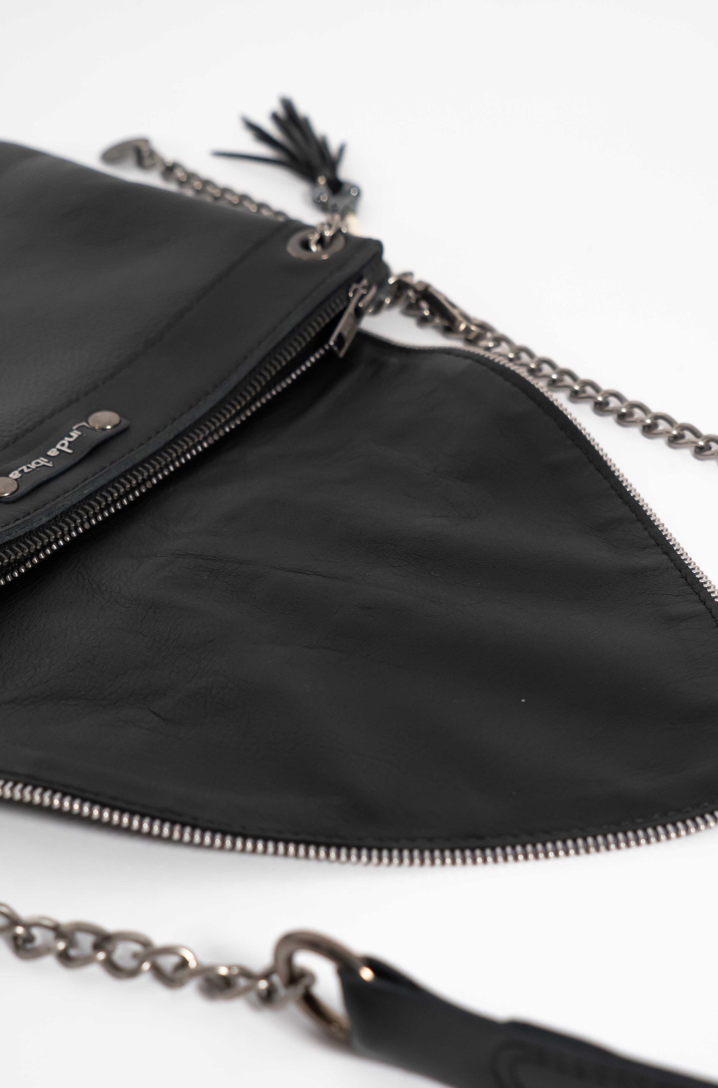 Handmade black leather crossbody bag, a statement piece capturing the soul of Ibiza.