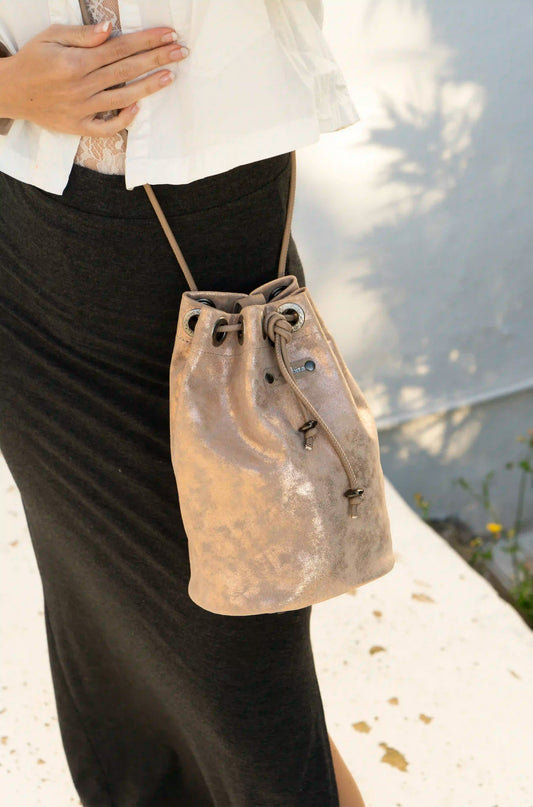 Premium pink leather bucket bag handcrafted in Ibiza, featuring a unique artisanal texture and versatile 3-in-1 multifunction design.