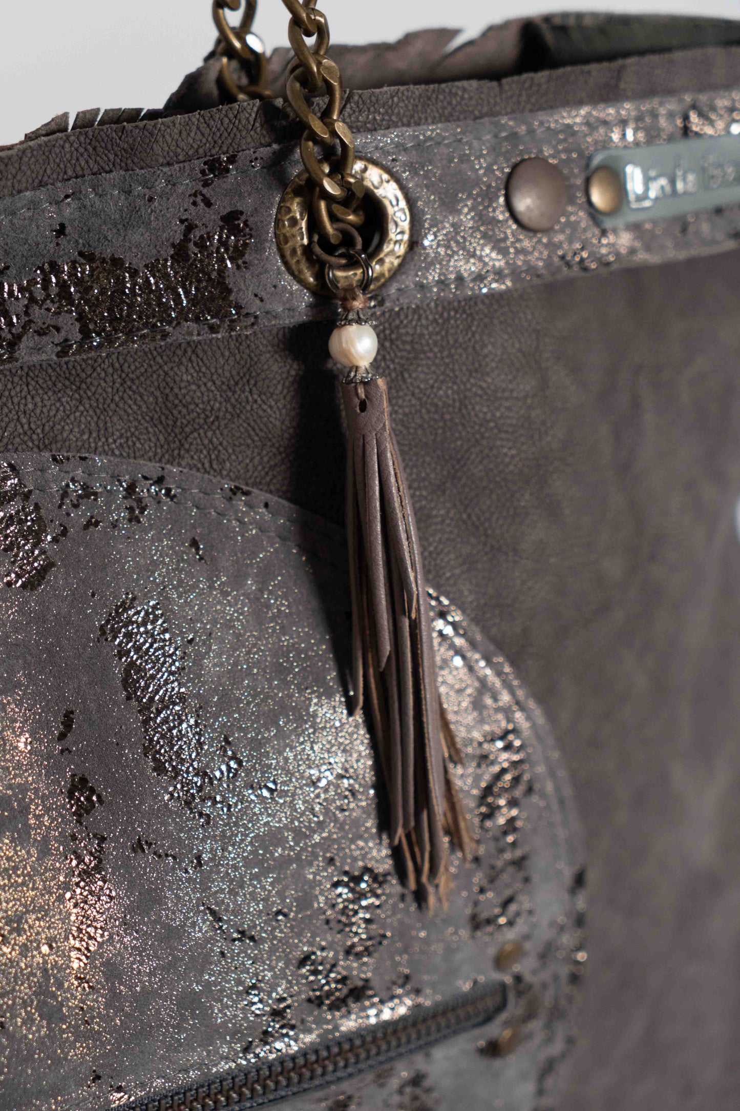 Handmade textured  purple leather shopping bag with chain and leather straps.