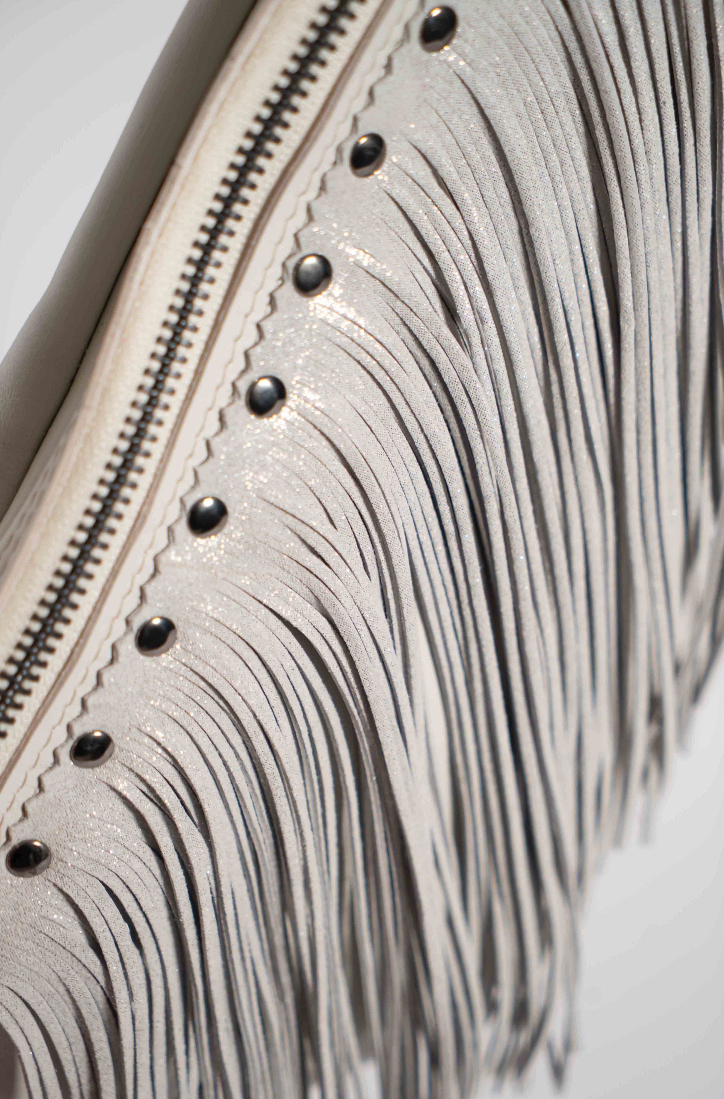 Handmade white leather sling bag with fringes