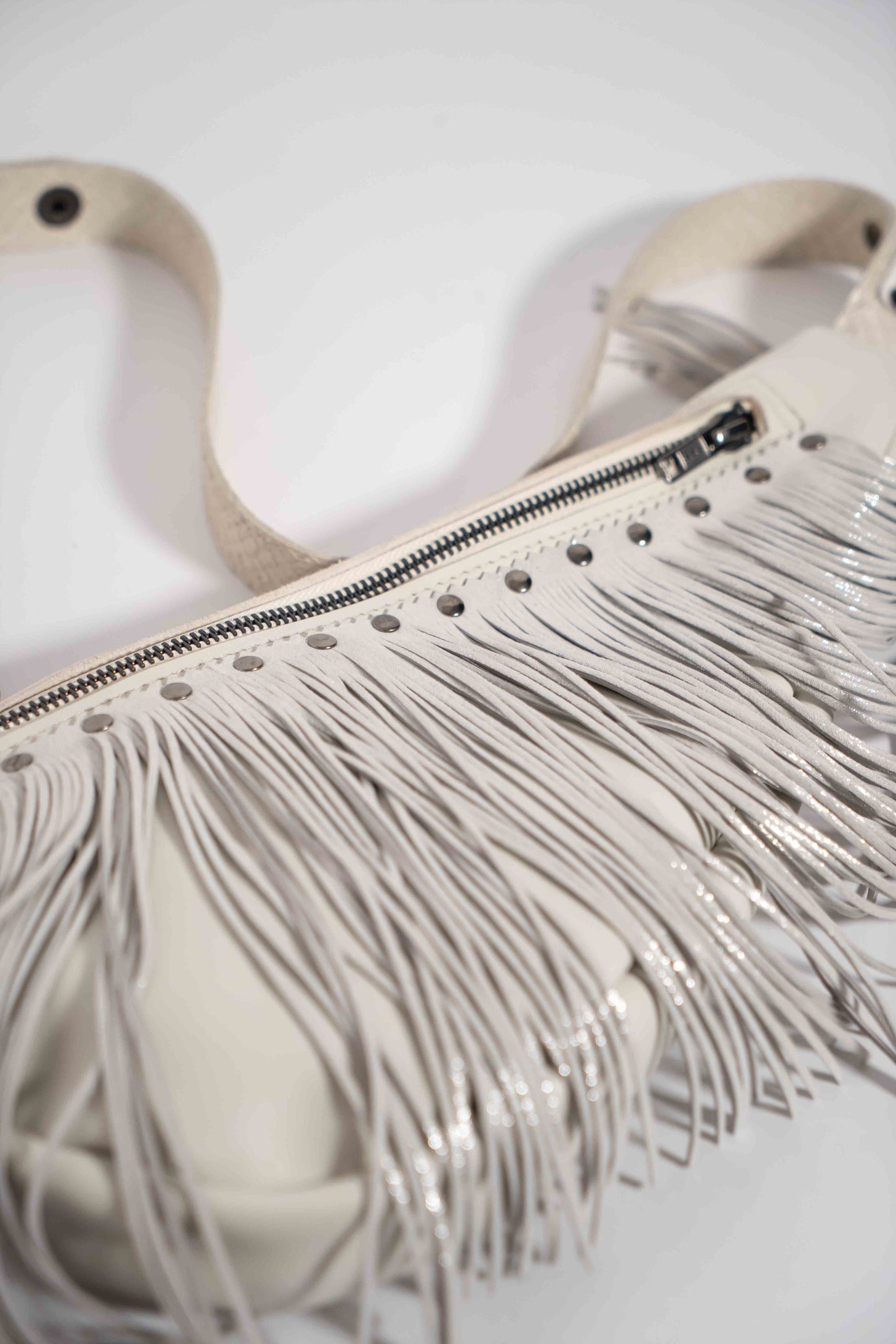 Handmade white leather sling bag with fringes