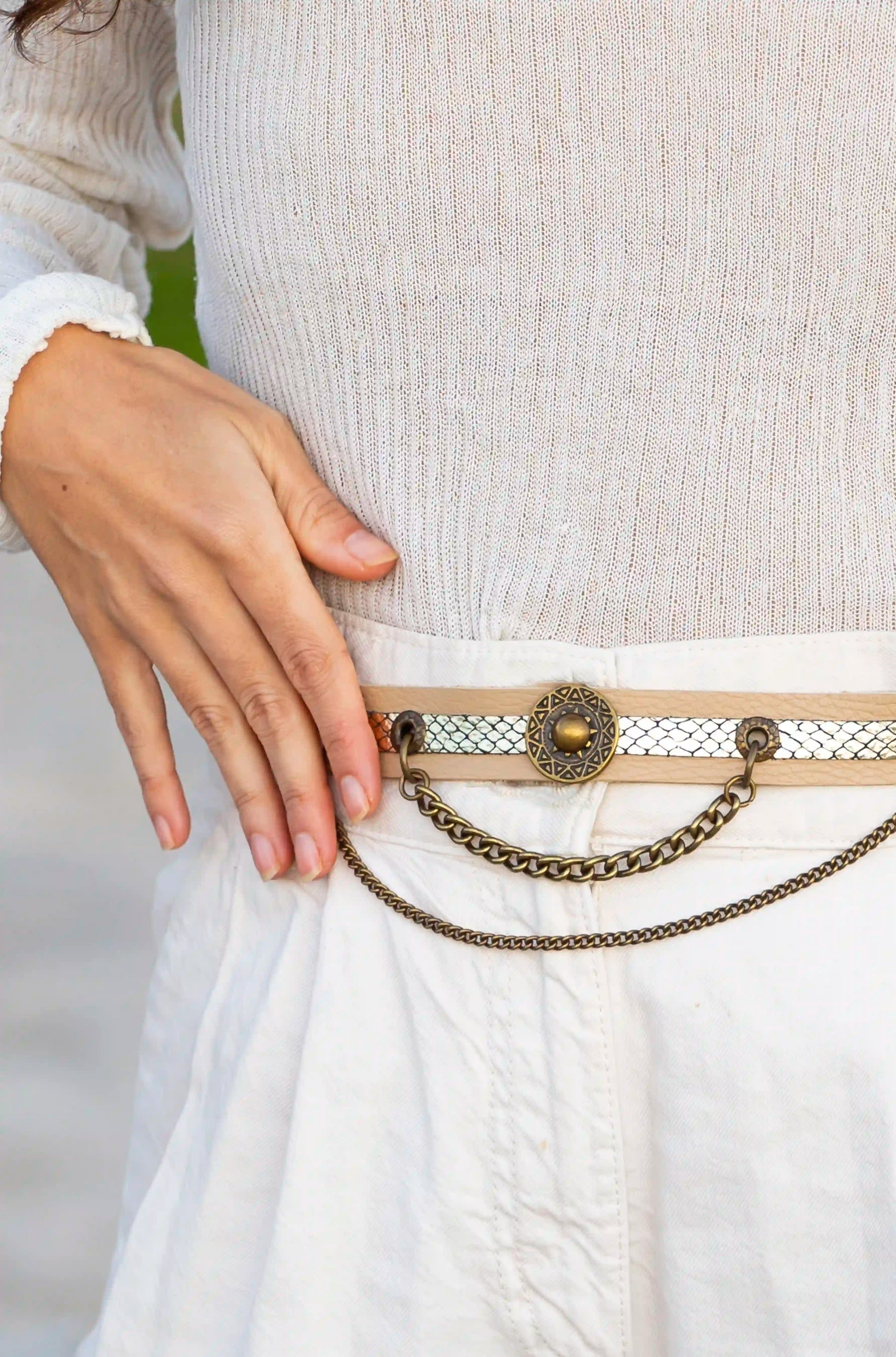 Beige snake leather belt used as a unique accessory for boots, handcrafted in Ibiza.