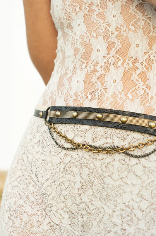 Close-up of a handmade black floral textured leather belt, artisan hand-carved accessory by Linda Ibiza.