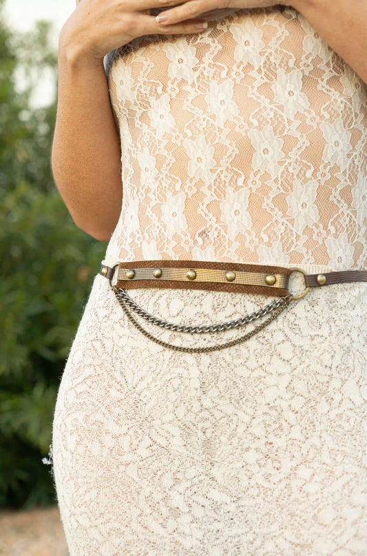 Close-up of a handmade brown textured leather belt with antique buckle, handcrafted artisan accessory by Linda Ibiza.