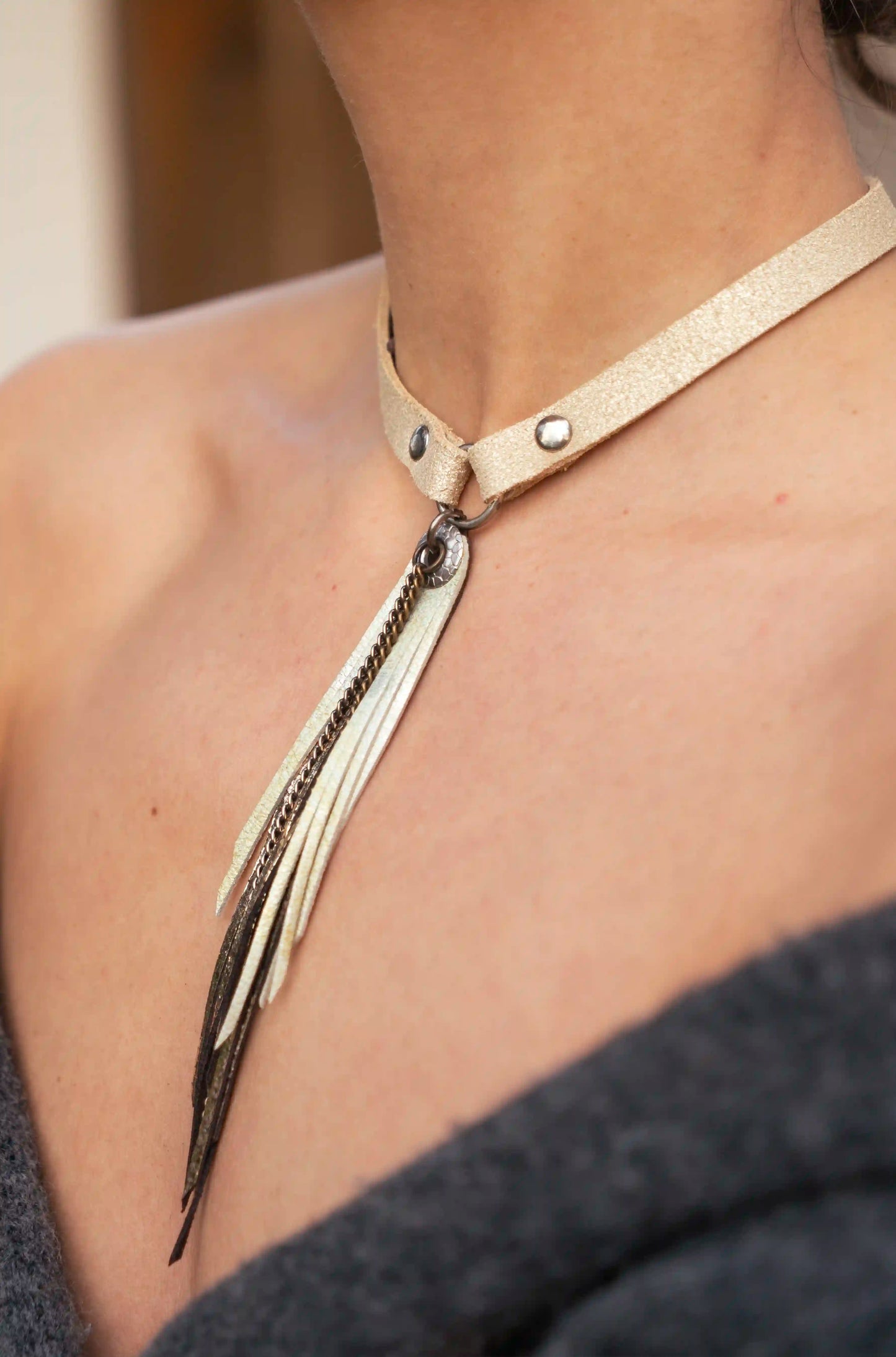 Woman wearing the handmade leather and gold statement necklace inspired by Ibiza.