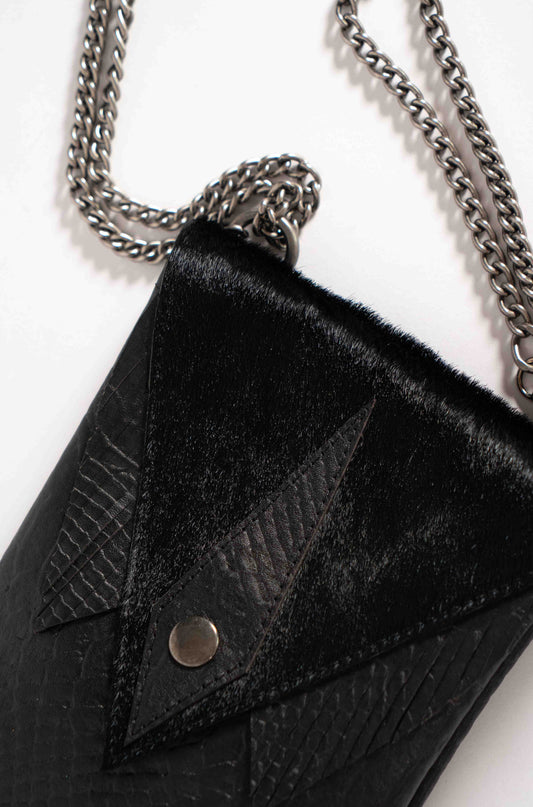 Small and stylish black leather bag with an adjustable chain strap by Linda Ibiza.