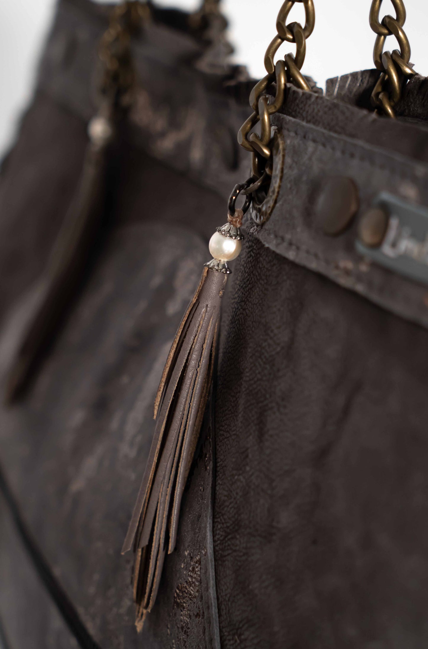 Handmade textured  purple leather shopping bag with chain and leather straps.