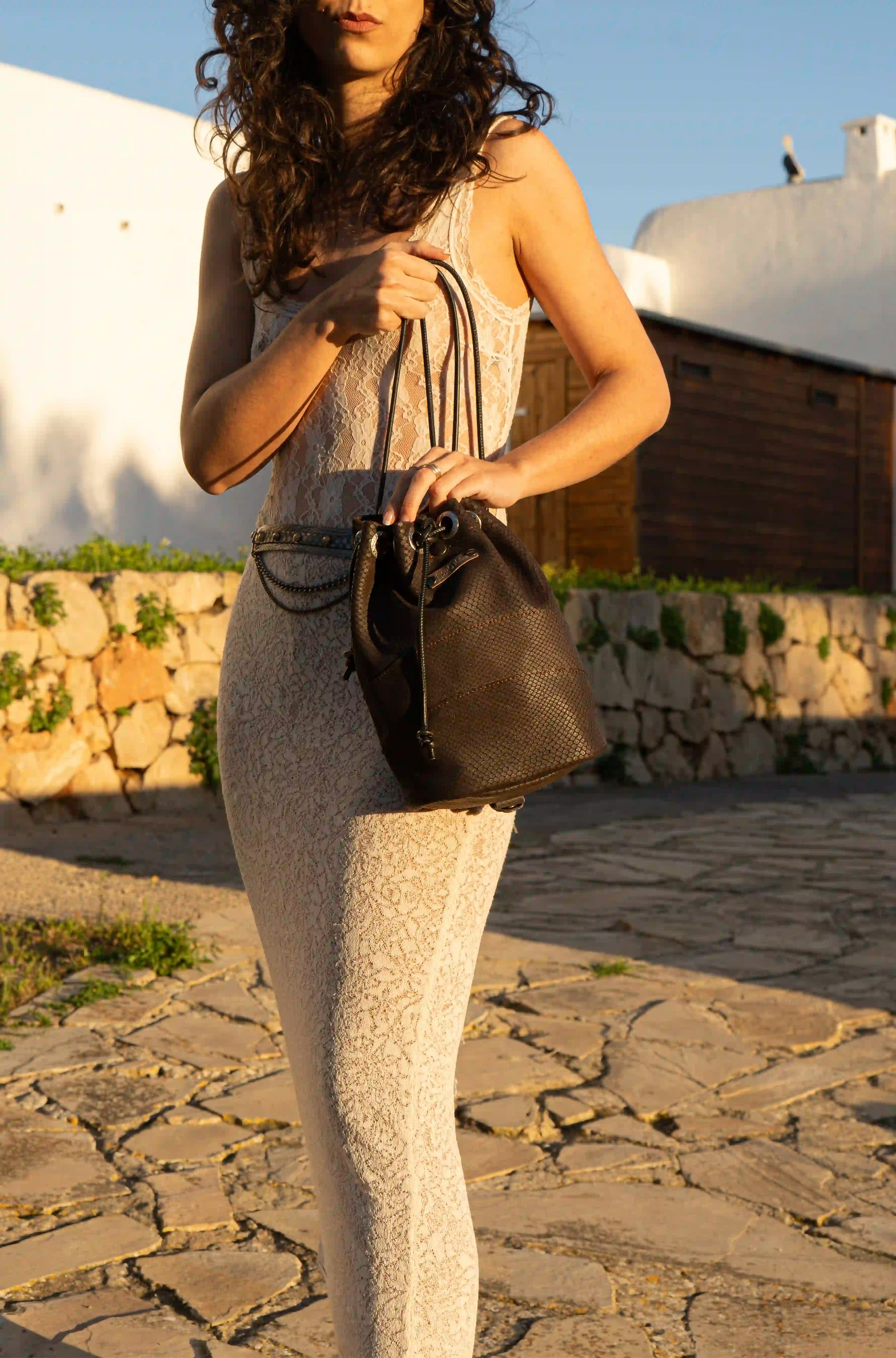 Close-up of the premium brown textured leather and artisan hand-carved details of the multifunction bag from Ibiza.