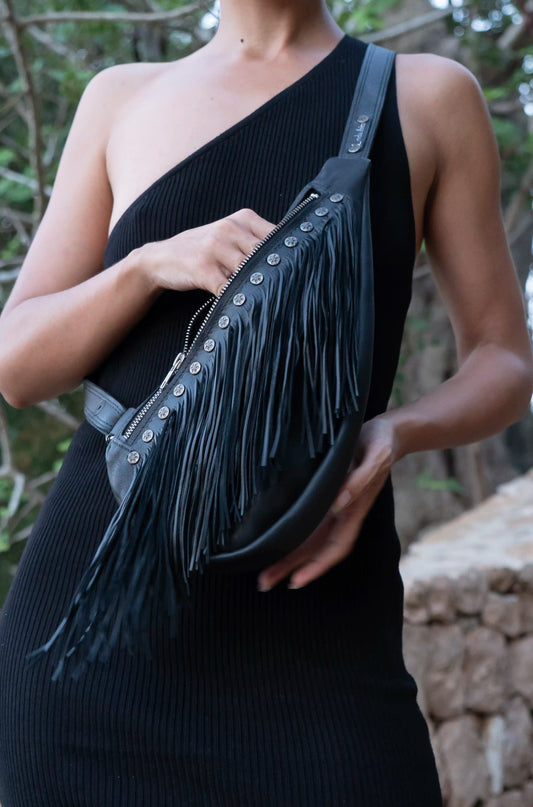 Handmade black premium leather fringed sling bag with metallic stud details, handcrafted in Ibiza by Linda Ibiza Design.