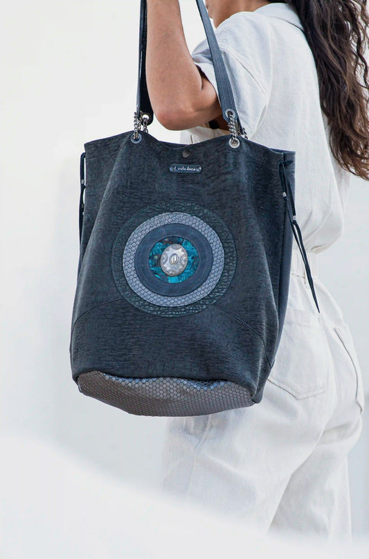Premium black canvas and leather tote bag with a hand-carved circular mandala design, handcrafted in Ibiza by Linda Ibiza Design.