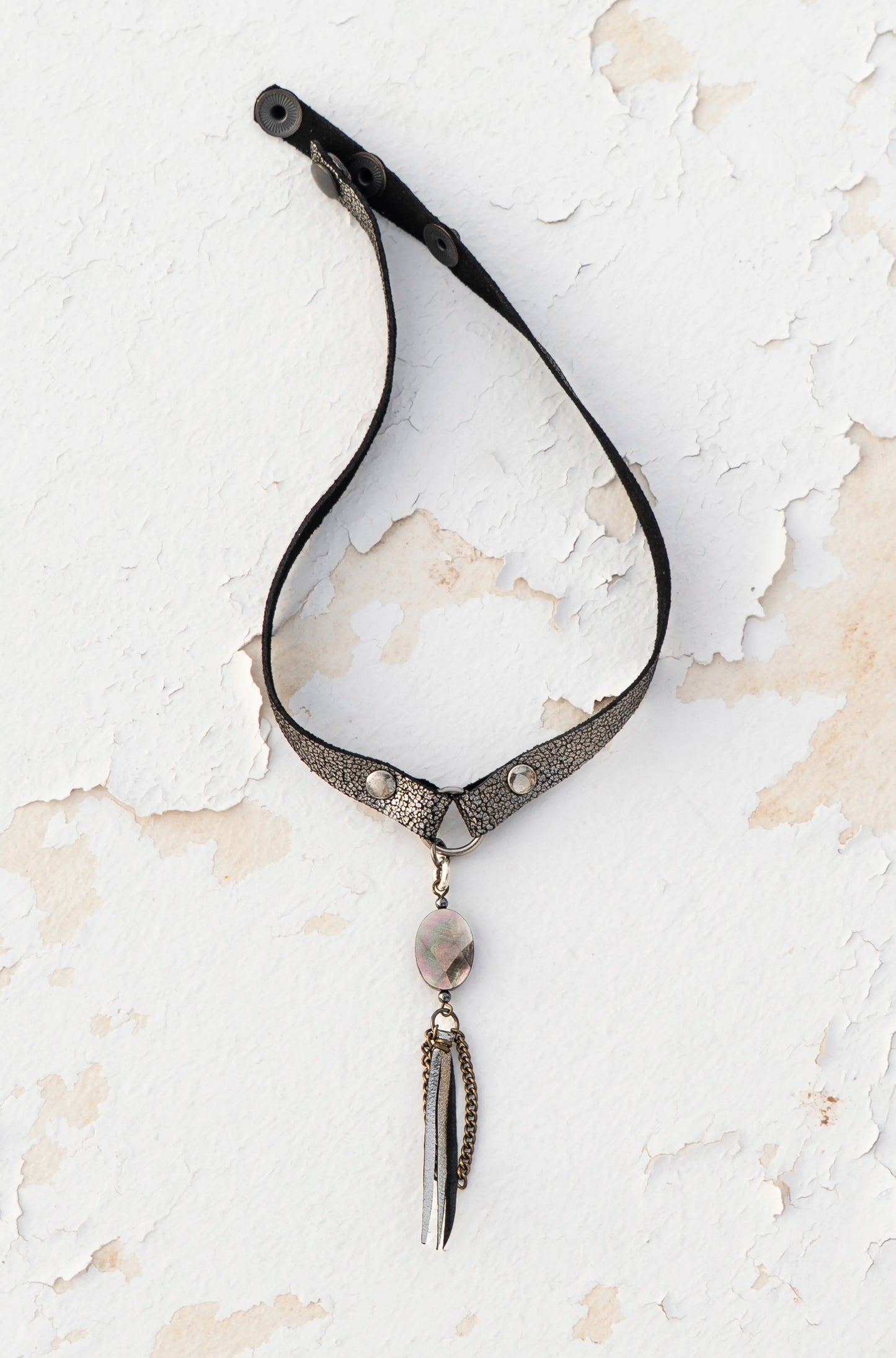Close-up of iridescent mother-of-pearl on silver metallic leather, artisan craftsmanship made in Ibiza.