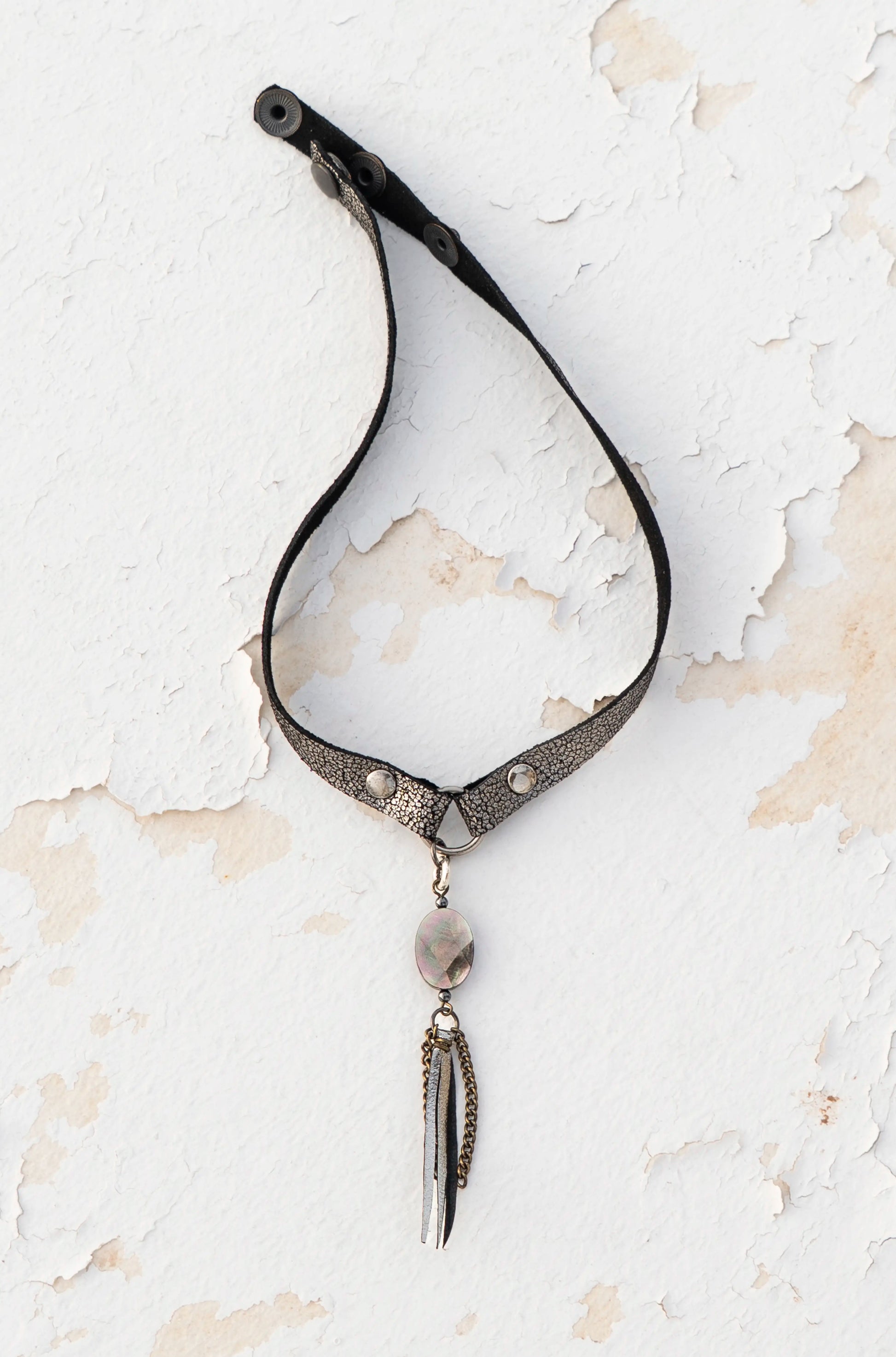 Close-up of iridescent mother-of-pearl on silver metallic leather, artisan craftsmanship made in Ibiza.