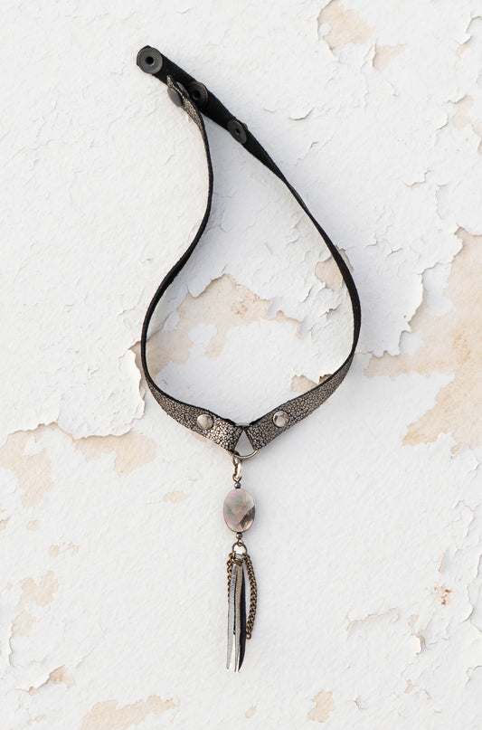 Close-up of iridescent mother-of-pearl on silver metallic leather, artisan craftsmanship made in Ibiza.